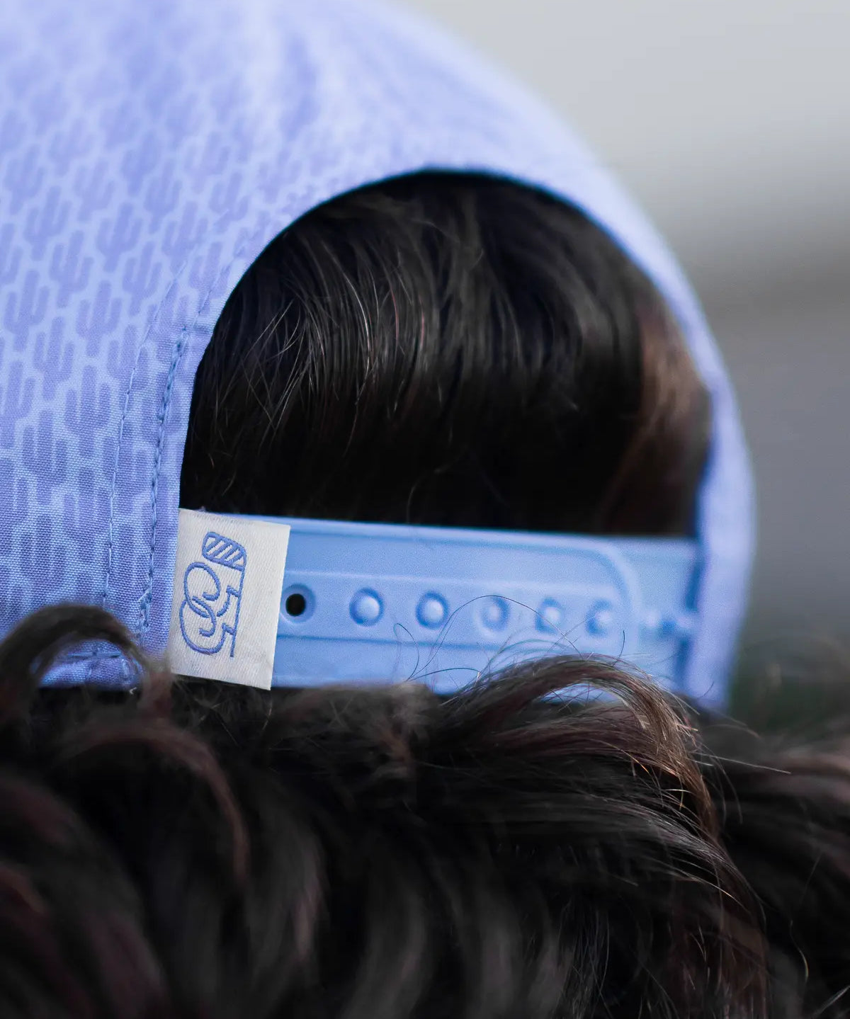 Close-up of a blue cap with a brand label on a blurred background