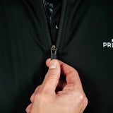 Hand zipping a black jacket with a brand logo on a dark background