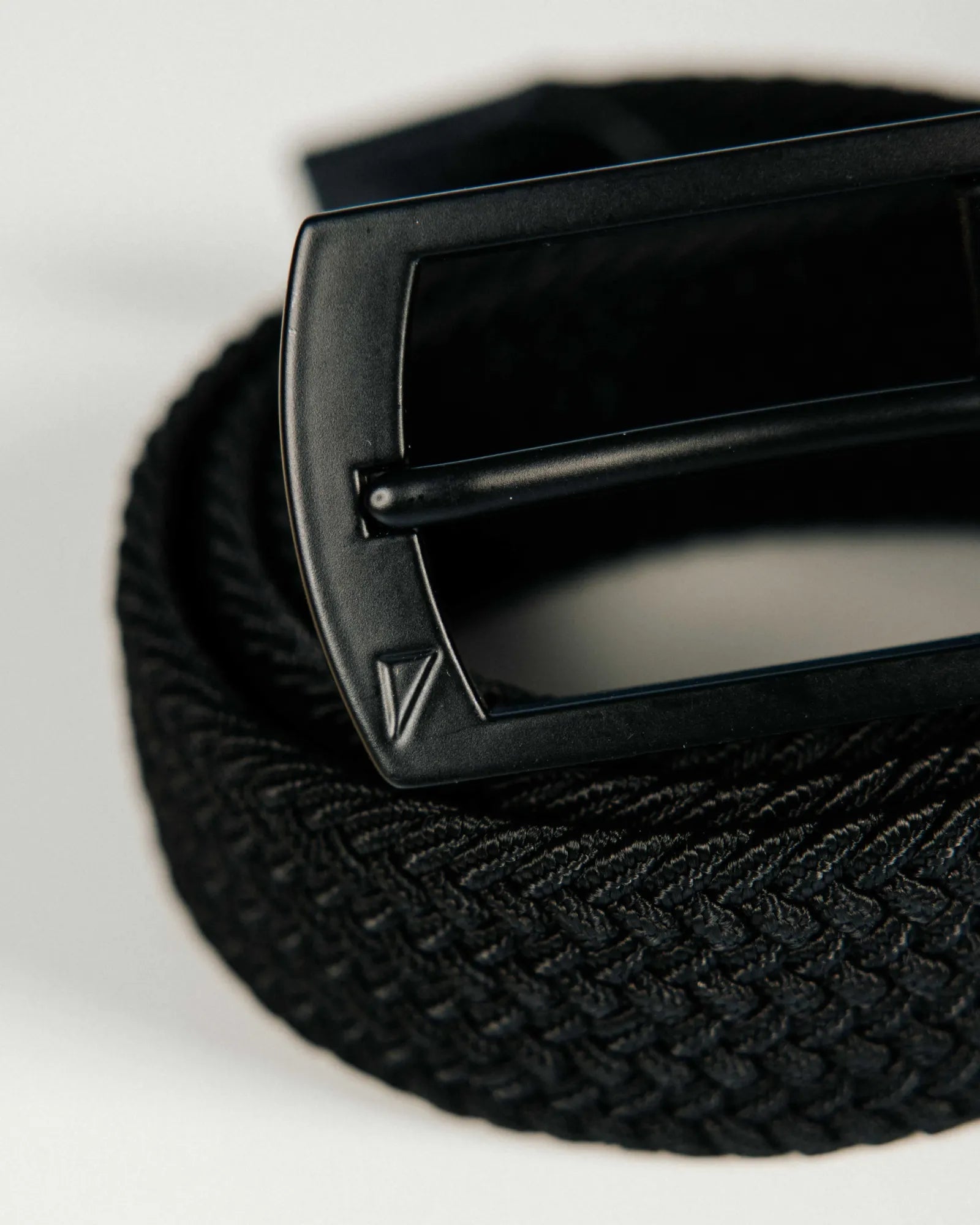 Black belt with a buckle on a light gray background