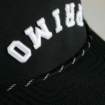 Primo embroidered logo on front of cap, close up details