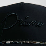 Black cap with 'Primo' embroidery on a light gray background