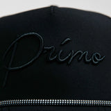 Black cap with 'Primo' embroidery on a light gray background