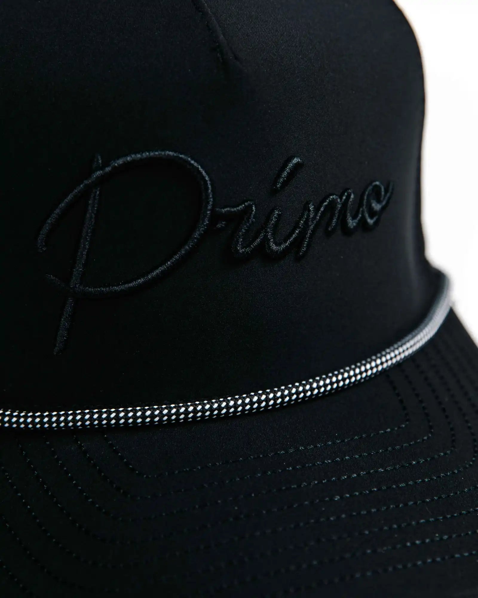 Black cap with 'Primo' embroidery on a white background