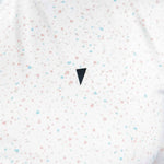 White shirt with colorful speckles and a black triangle design on a white background