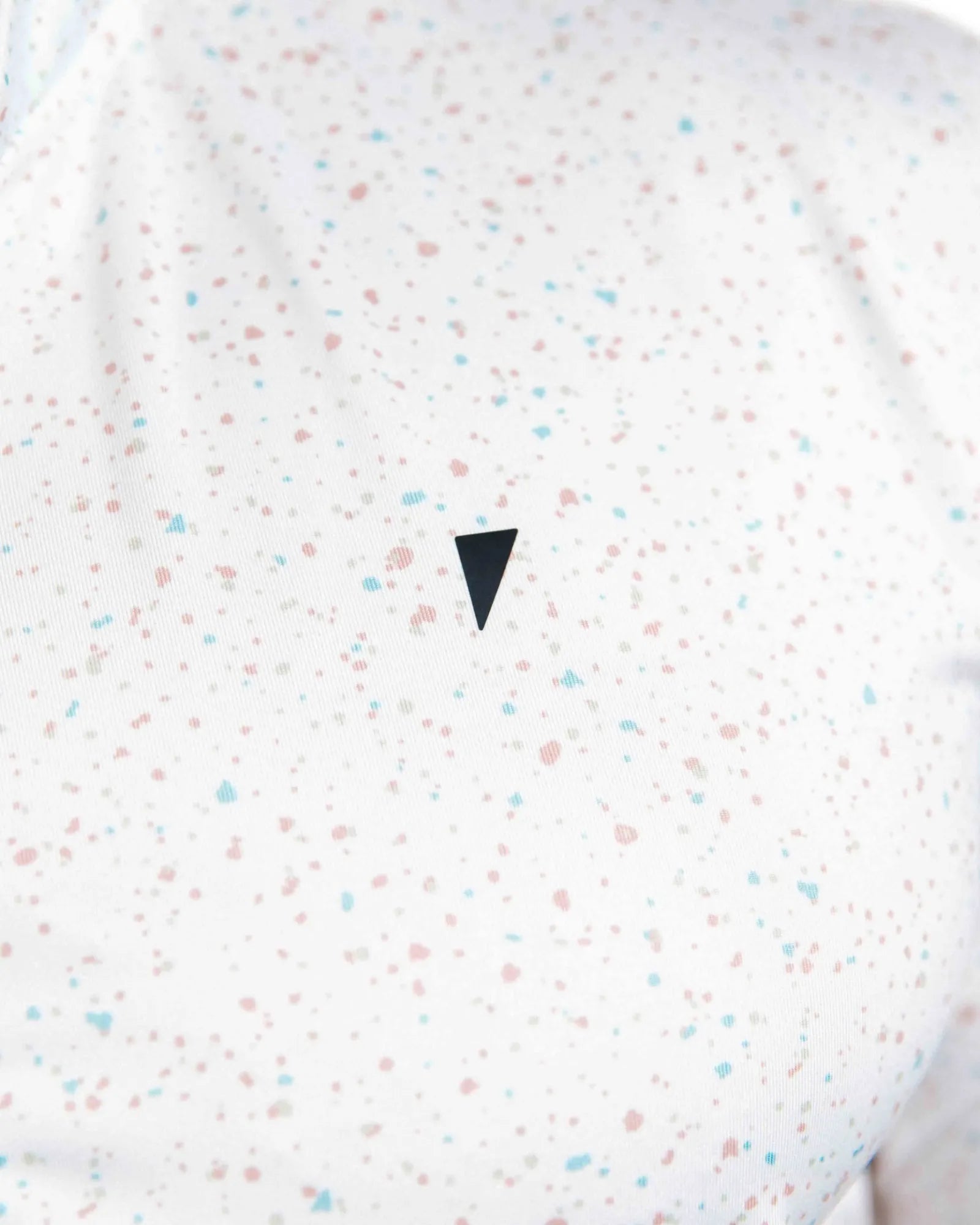 White shirt with colorful speckles and a black triangle design on a white background