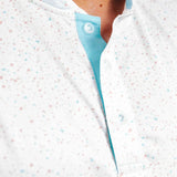Close-up of a person wearing a light white and blue polo with front button placket on top