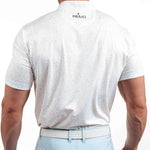 Man wearing a white polo shirt with 'Primo' branding on the back, standing against a white background.
