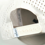 Close up detail of back of cap with mesh and snapback closure.