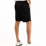 Person wearing black shorts on a white background