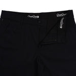 Close-up of black pants with 'Good Good' branding on waistband and pocket.