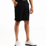 Person wearing black shorts on a white background