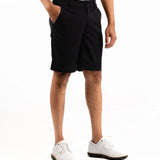 Person wearing black shorts on a white background