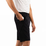 Person wearing black shorts and a white striped shirt on a white background