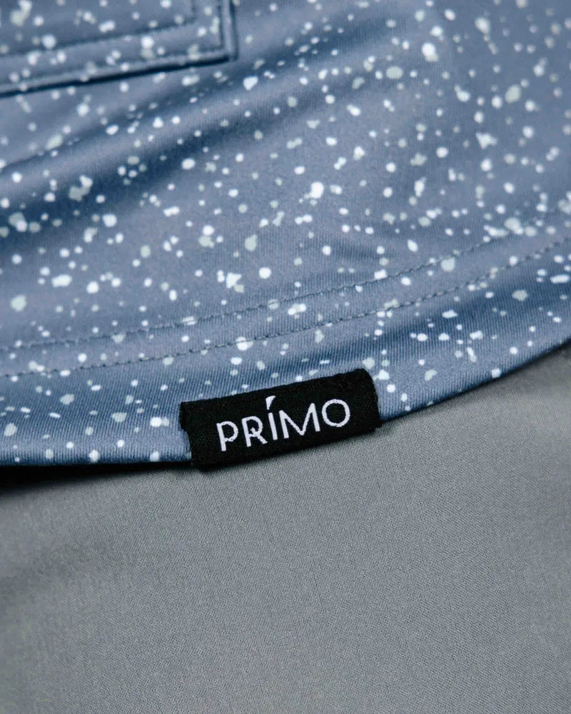 Close-up of a blue speckled fabric with a Primo label.