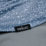 Close-up of a blue speckled fabric with a Primo label.