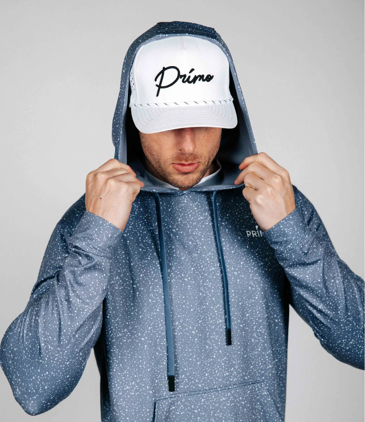 Man modelling the Primo Blue hoodie with a speckled subtle pattern