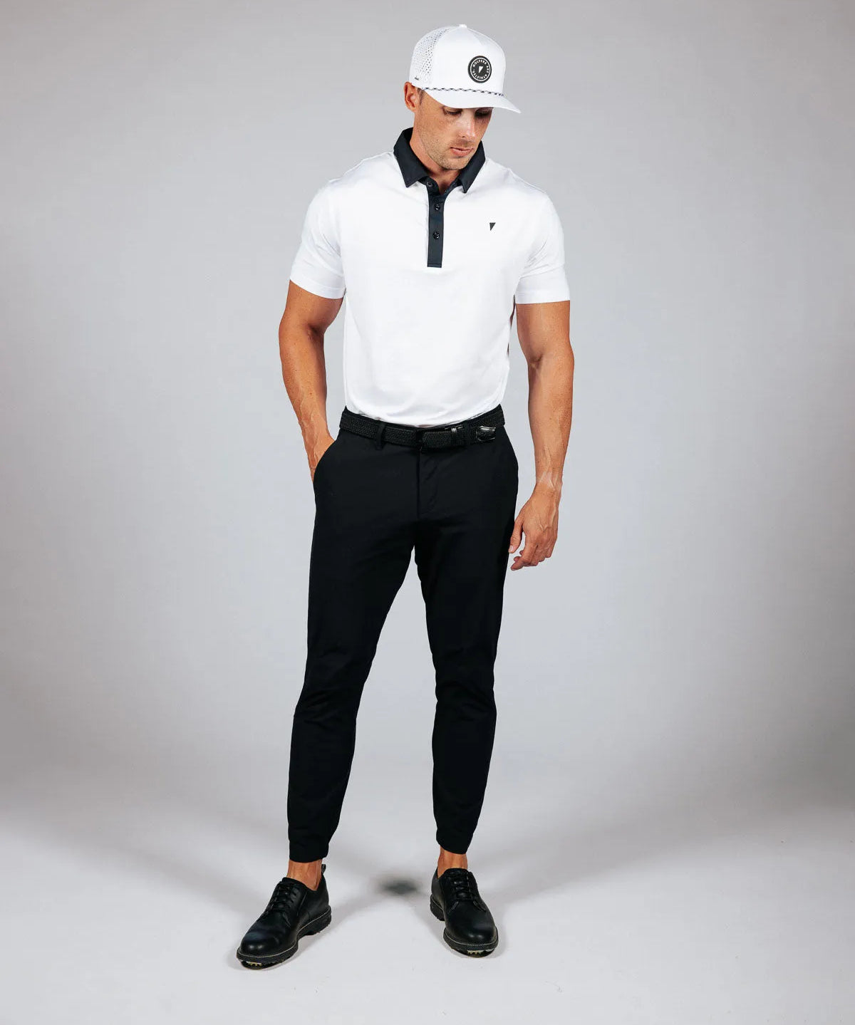 Man wearing golf attire on a light grey background