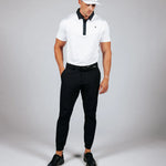 Man wearing golf attire on a light grey background