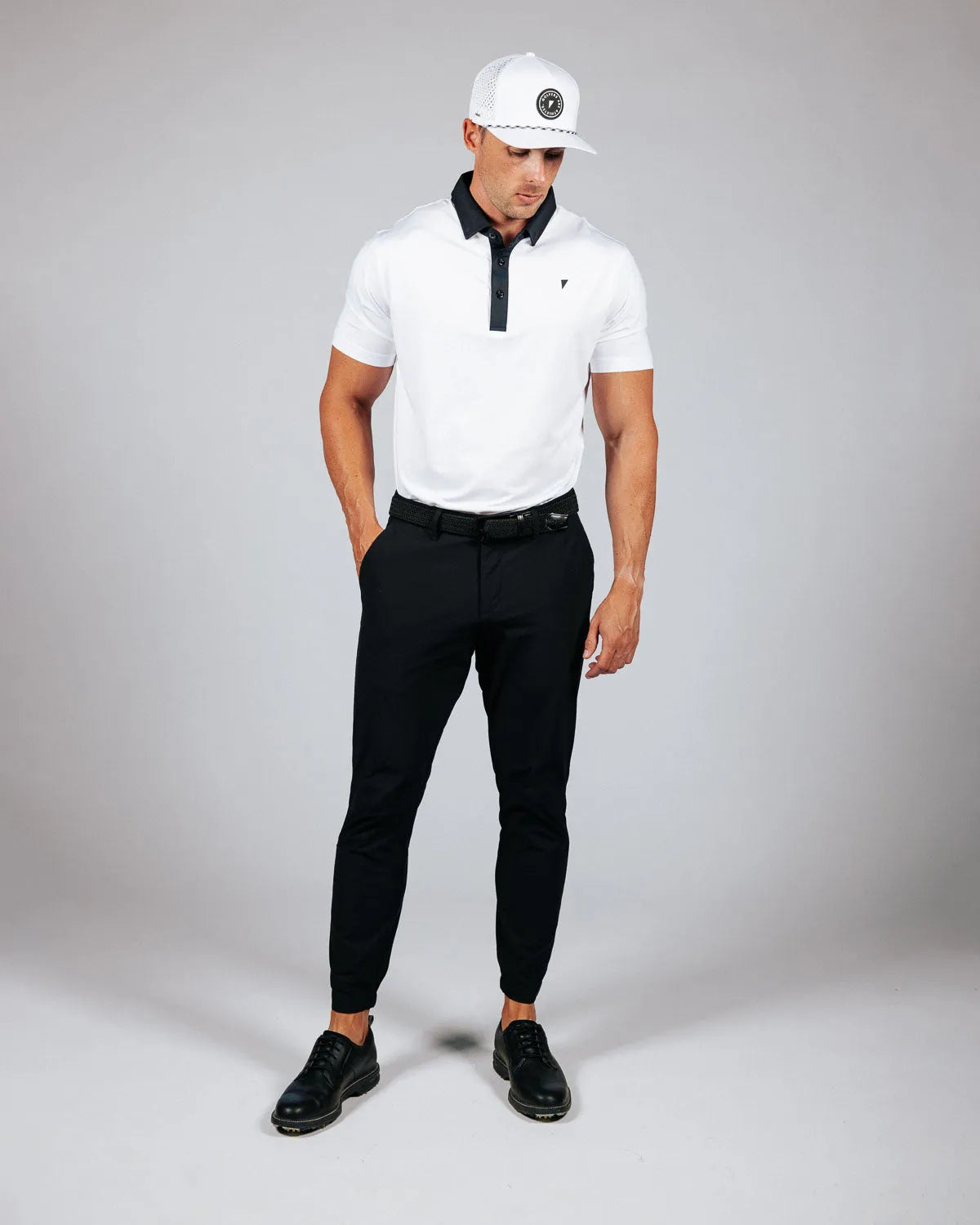 Man wearing golf attire on a light grey background