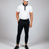 Man wearing golf attire on a light grey background