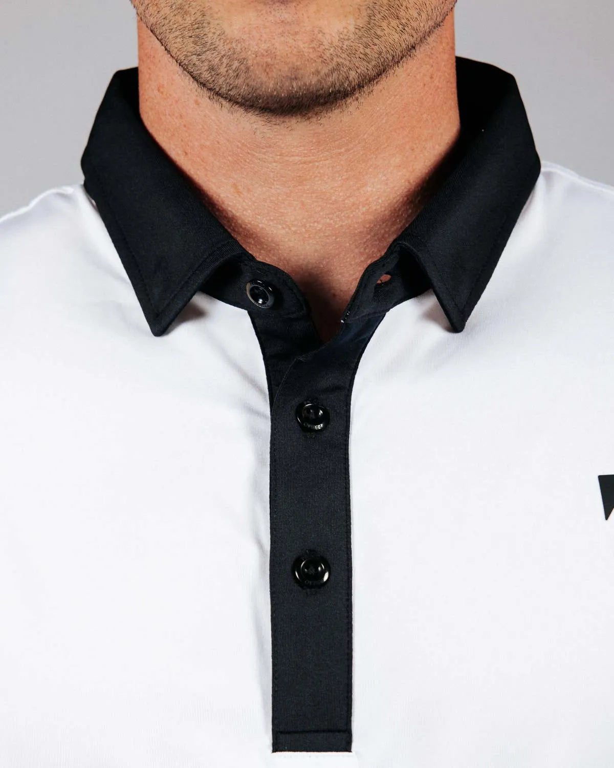 Close up of the front quarter placket with buttons on golf shirt.
