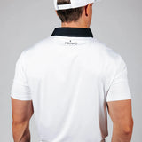 Man wearing a white polo shirt with 'Primo' logo on the back against a gray background