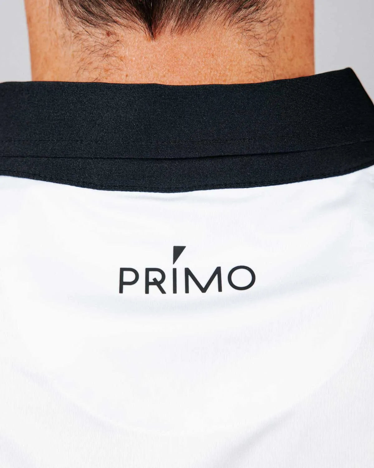 White shirt with 'PRIMO' logo on a plain background