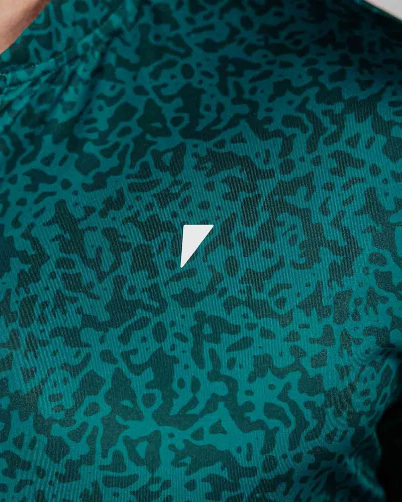 Green patterned fabric with a white triangle logo