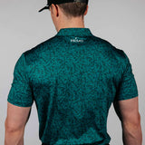 Man wearing a green patterned shirt with 'Primo' branding on the back, standing against a plain background.