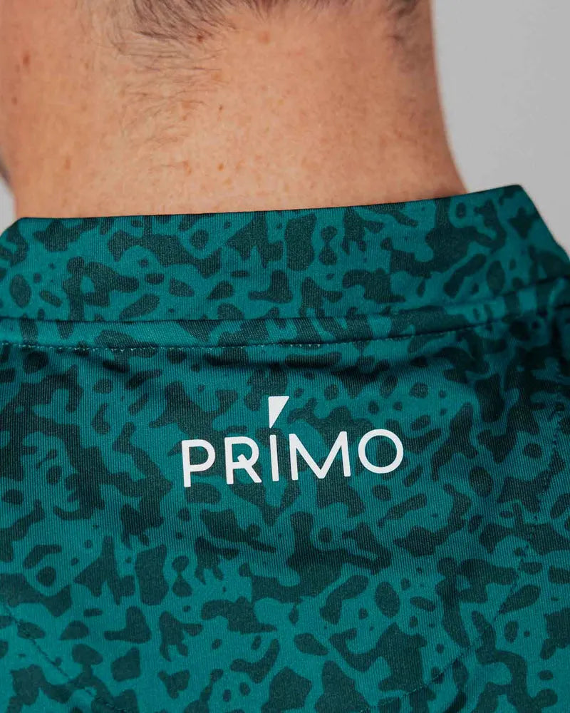 Green patterned fabric with 'Primo' logo on a close-up of skin.