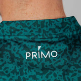 Green patterned fabric with 'Primo' logo on a close-up of skin.