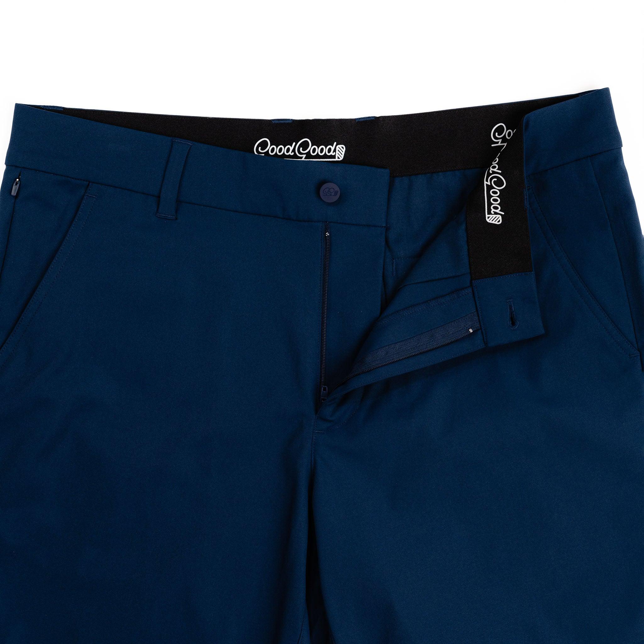Close-up of blue pants with GoodGood label on waistband and pocket.