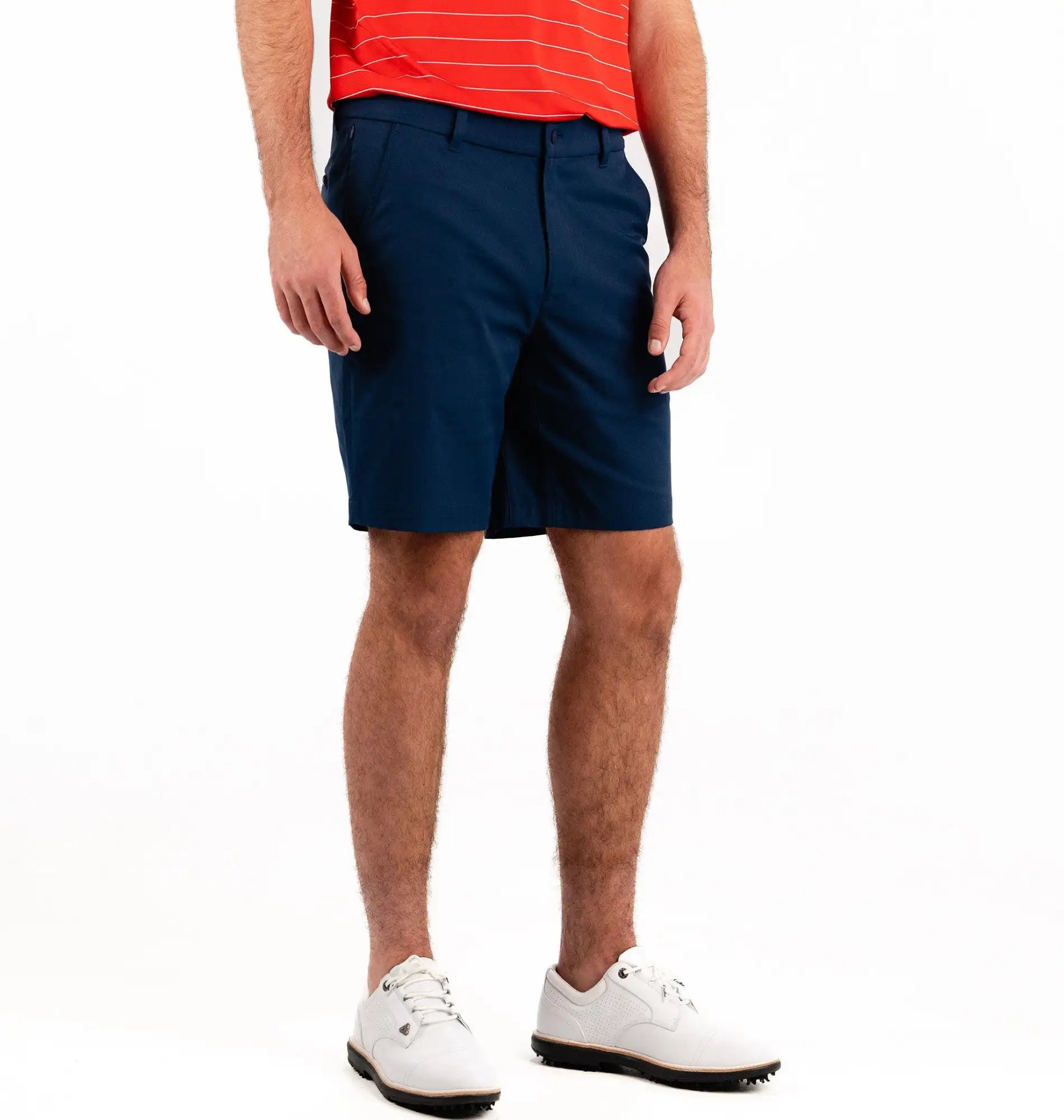 Person wearing navy shorts and a red shirt on a white background