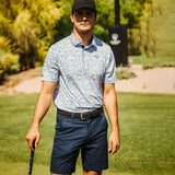 Man in golf attire on a golf course
