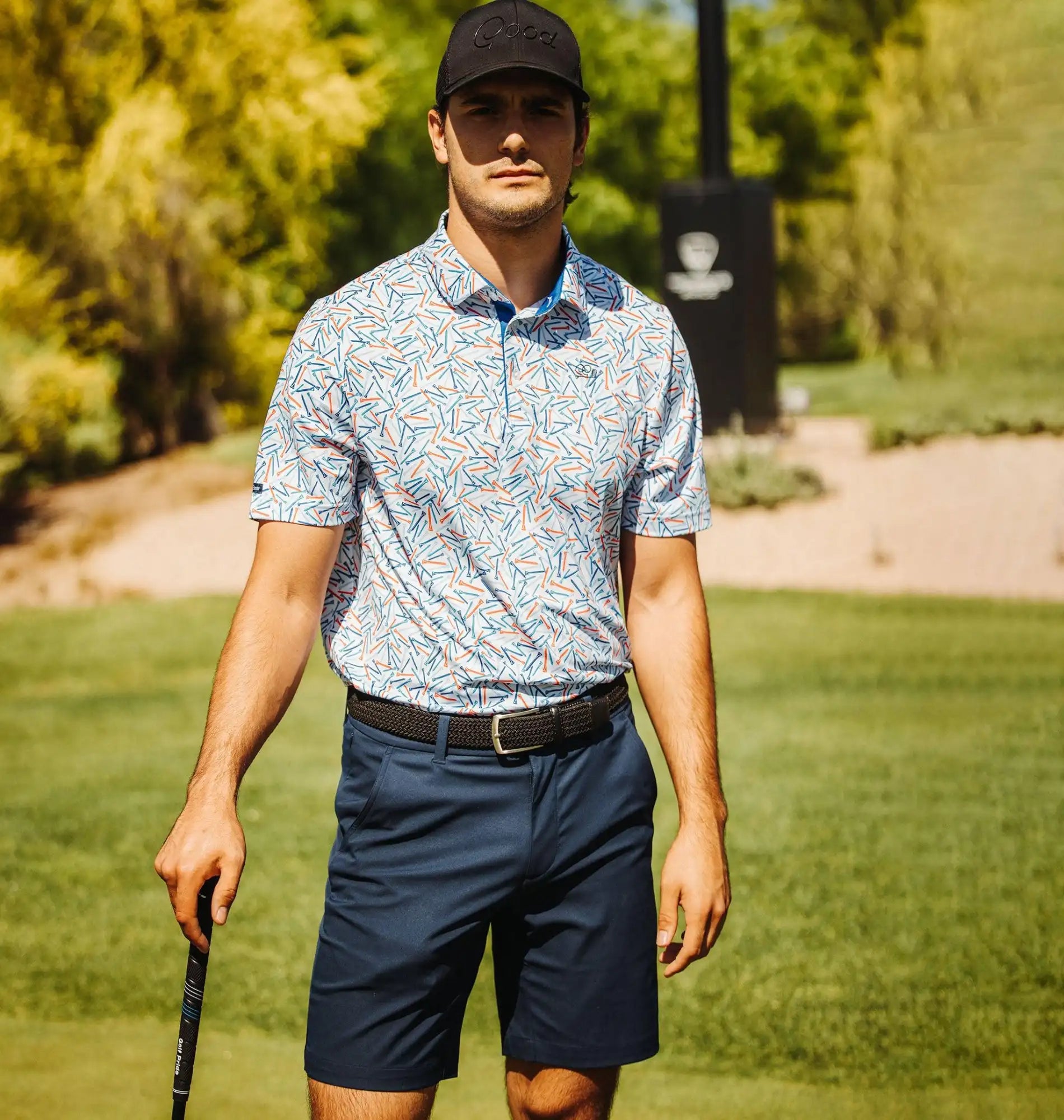 Man in golf attire on a golf course