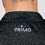 Black speckled shirt with 'PRIMO' logo on a plain background