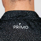 Black speckled shirt with 'PRIMO' logo on a plain background