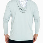 Light blue hoodie with patterned hood lining worn by a person on a white background