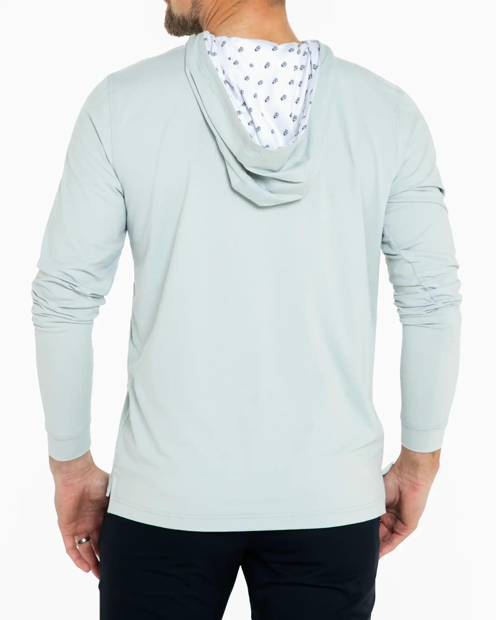 Light blue hoodie with patterned hood lining worn by a person on a white background