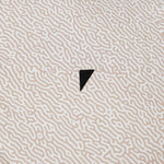 Textured beige surface with a black triangle in the center