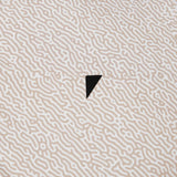Textured beige surface with a black triangle in the center