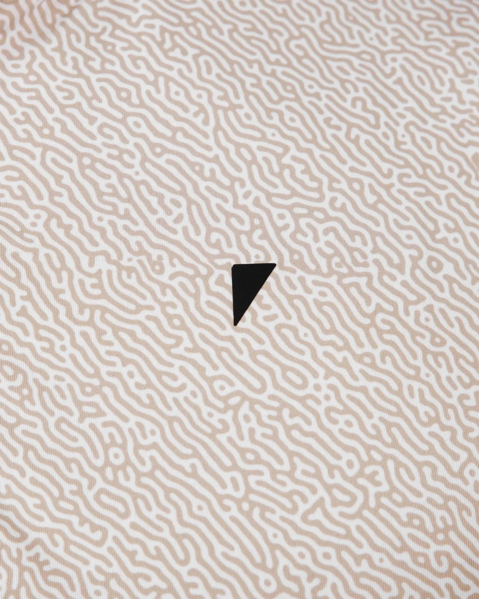 Textured beige surface with a black triangle in the center