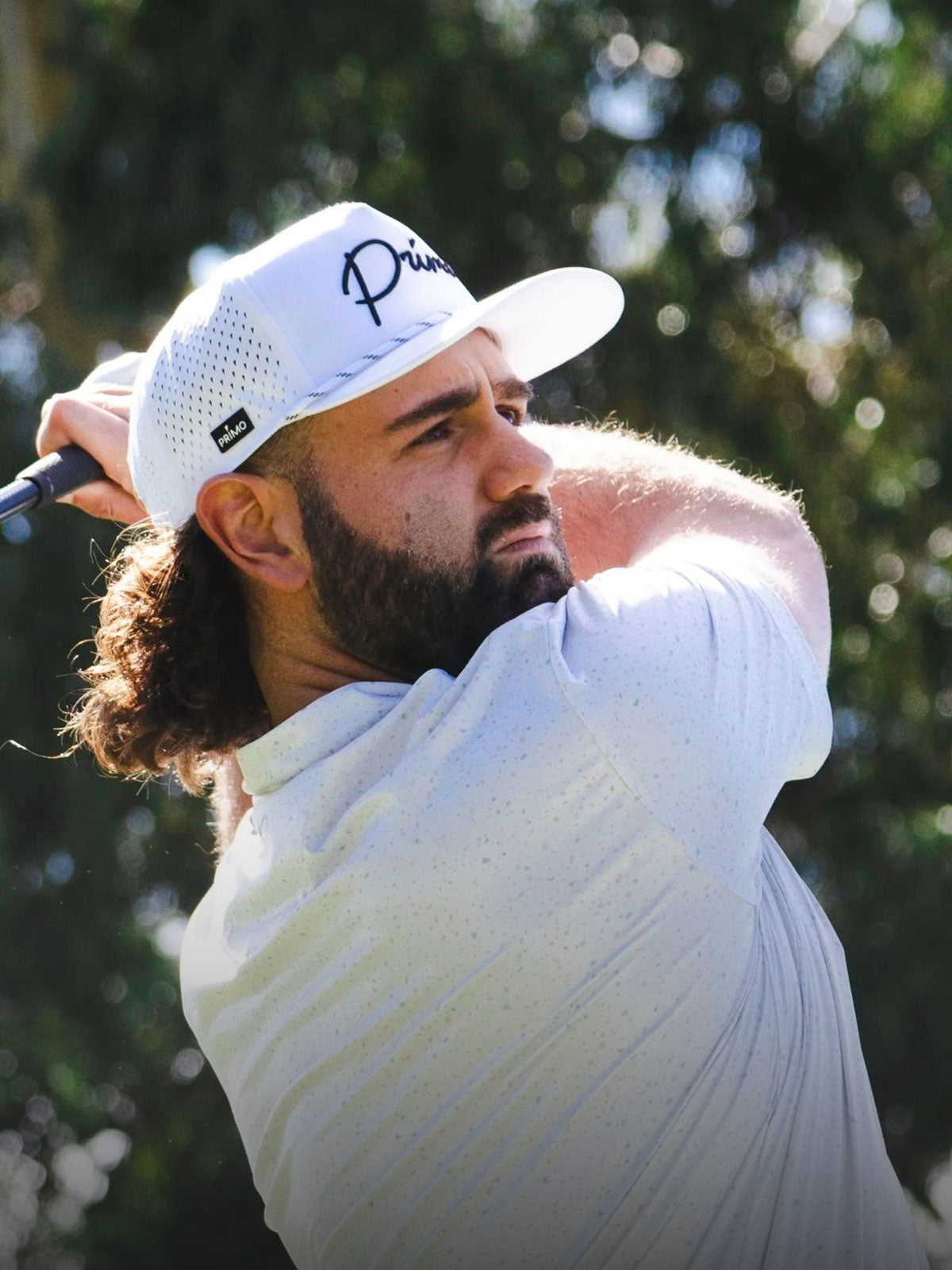 Golfer in action with a golf club on a golf course
