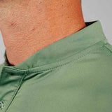 Close-up of a green shirt mock collar with a neutral background