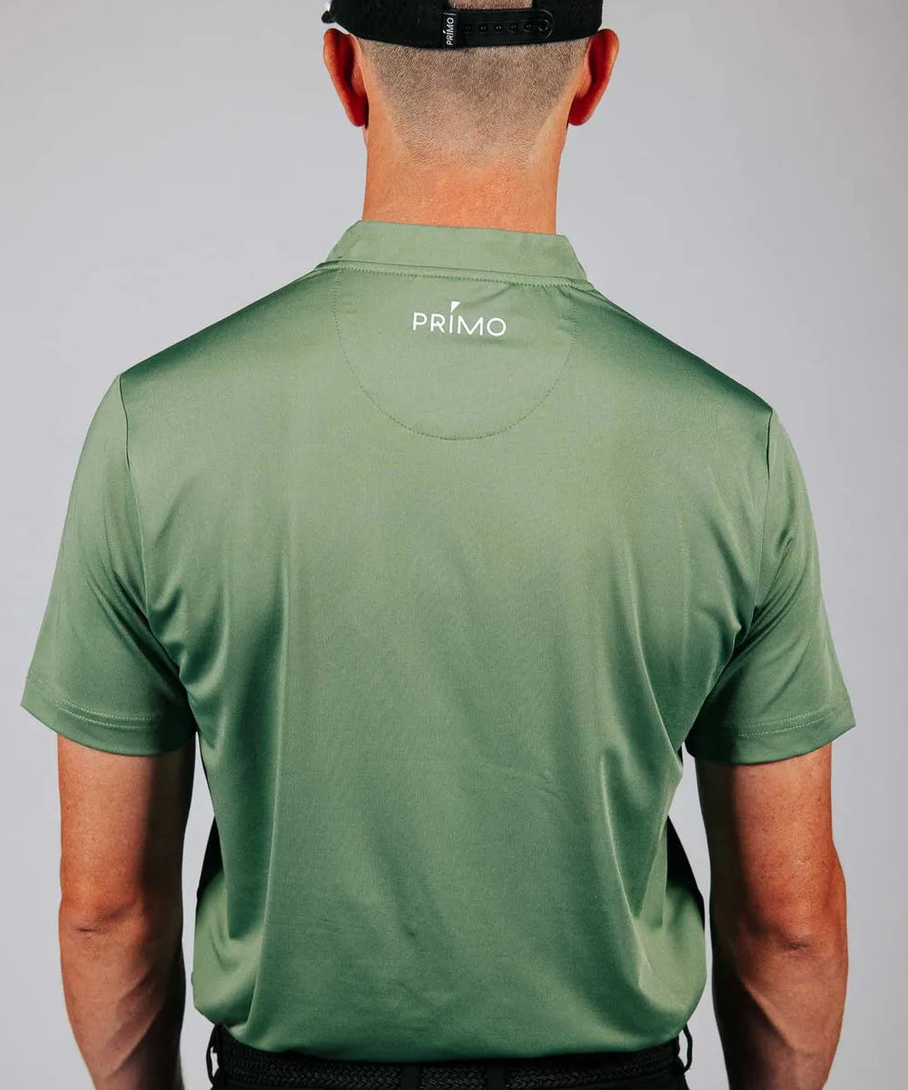 Person wearing a green 'Primo' polo shirt with a plain background