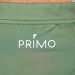 Back of green polo with 'PRIMO' logo in white