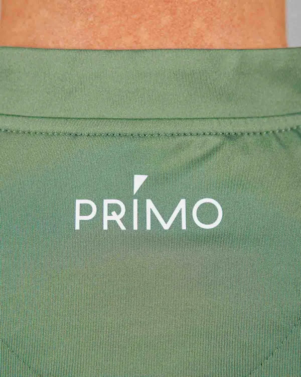 Back of green polo with 'PRIMO' logo in white