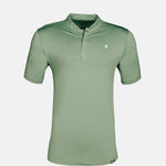 Green polo shirt on a light gray background