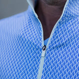 Close-up of a blue textured half-zip shirt with a blurred background