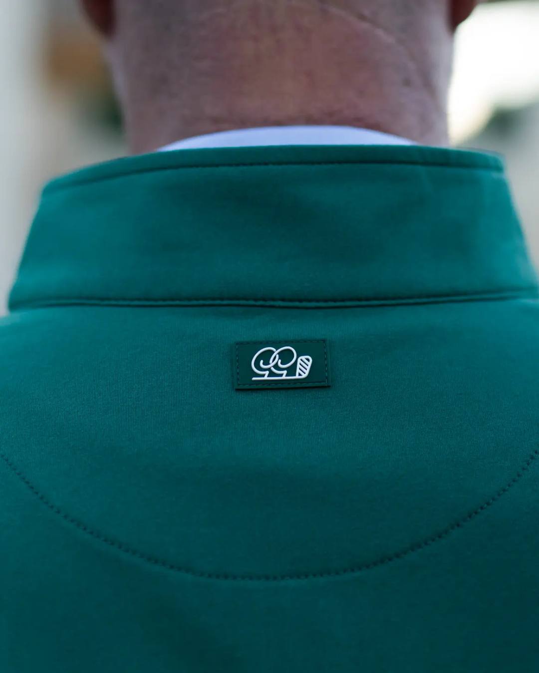 Green jacket with a logo on the chest area